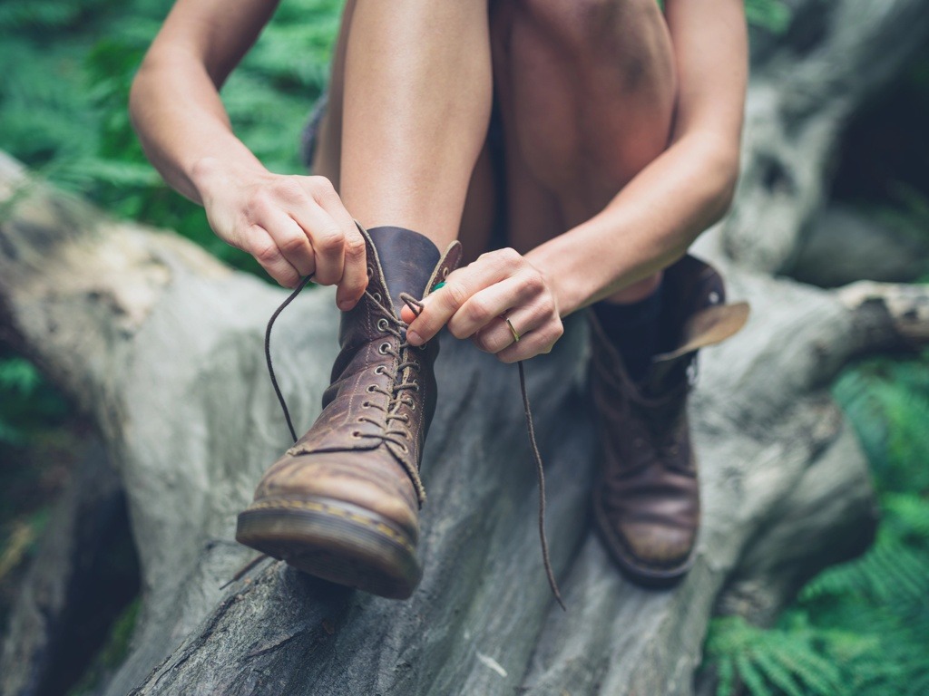 Jonge vrouw vetert haar schoenen 